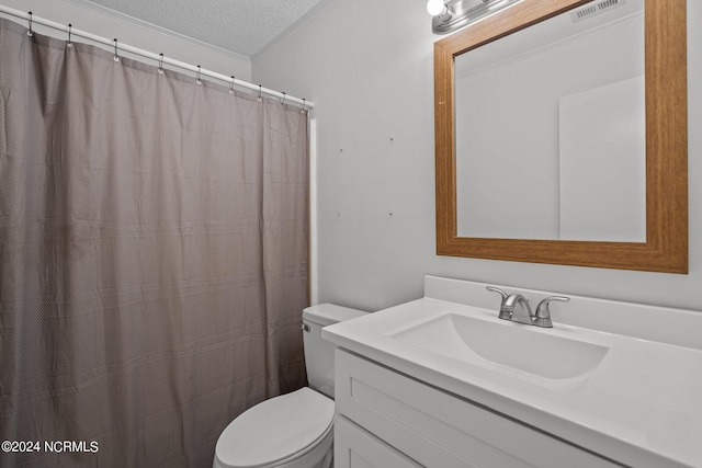 bathroom featuring vanity, toilet, and a textured ceiling