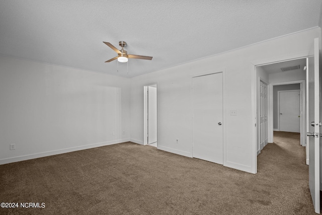 unfurnished bedroom featuring carpet, ceiling fan, and a textured ceiling