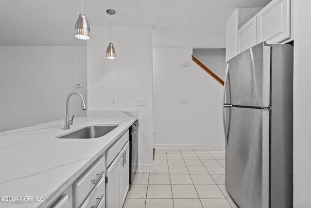 kitchen with sink, stainless steel fridge, dishwashing machine, light stone counters, and white cabinetry