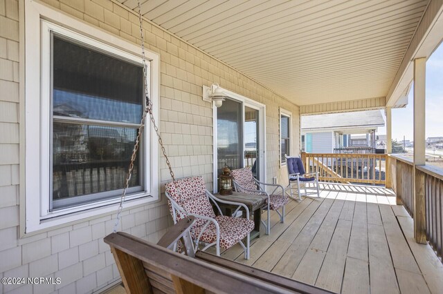 wooden terrace featuring covered porch