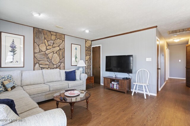 living room with hardwood / wood-style floors and a textured ceiling