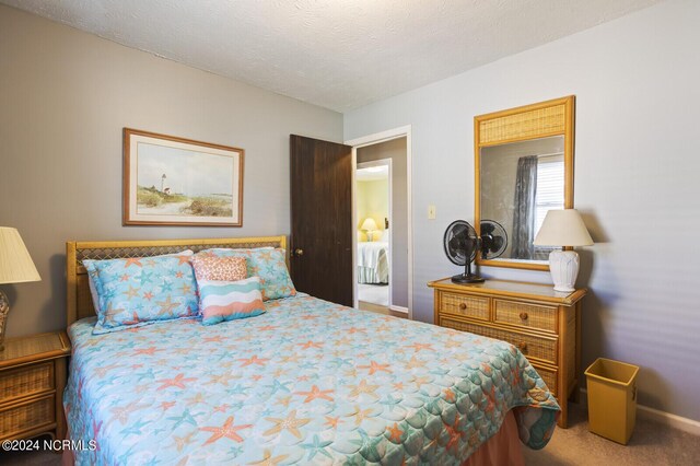 carpeted bedroom featuring a textured ceiling