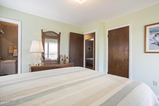 bedroom with connected bathroom and a closet