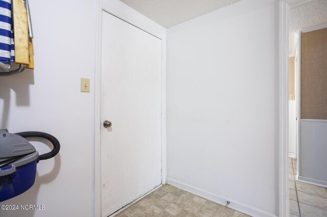 hallway with a textured ceiling