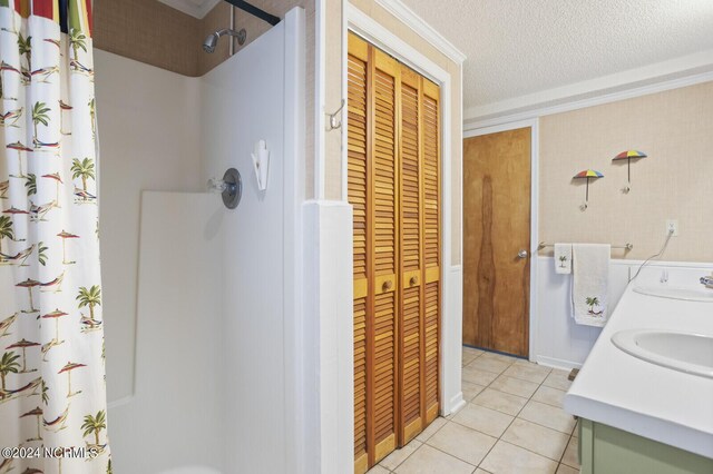 bathroom featuring vanity, tile patterned floors, and curtained shower