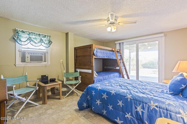 bedroom featuring ceiling fan, cooling unit, a textured ceiling, and access to outside