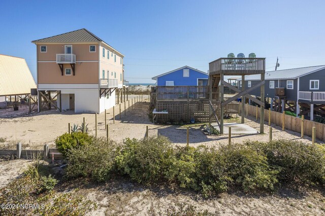 rear view of property with an AC wall unit and a wooden deck