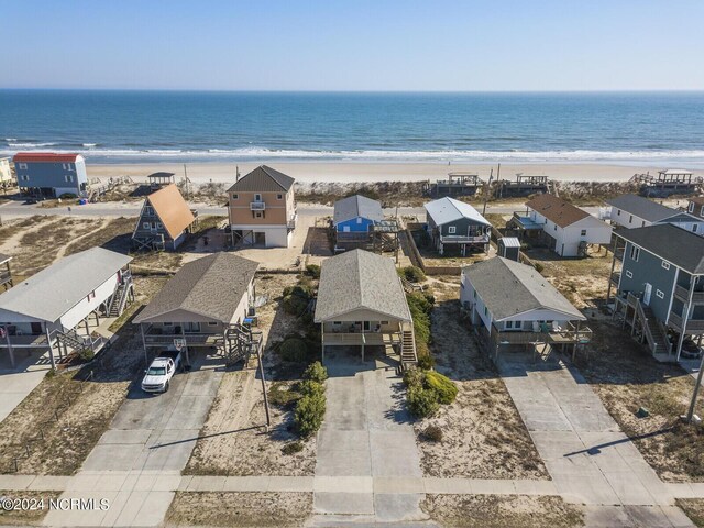 drone / aerial view with a beach view and a water view