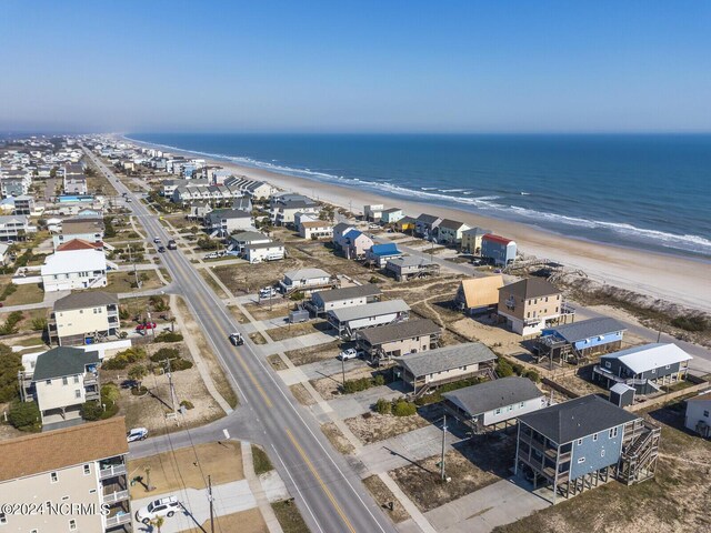 drone / aerial view with a water view and a beach view