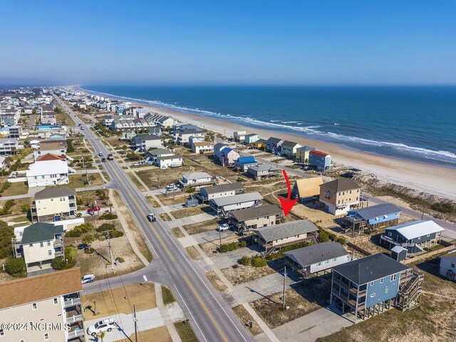 bird's eye view with a water view and a view of the beach