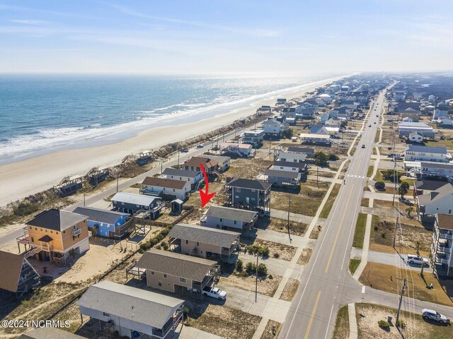 drone / aerial view featuring a view of the beach and a water view