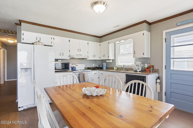 kitchen featuring ornamental molding, white appliances, dark wood-type flooring, sink, and white cabinetry