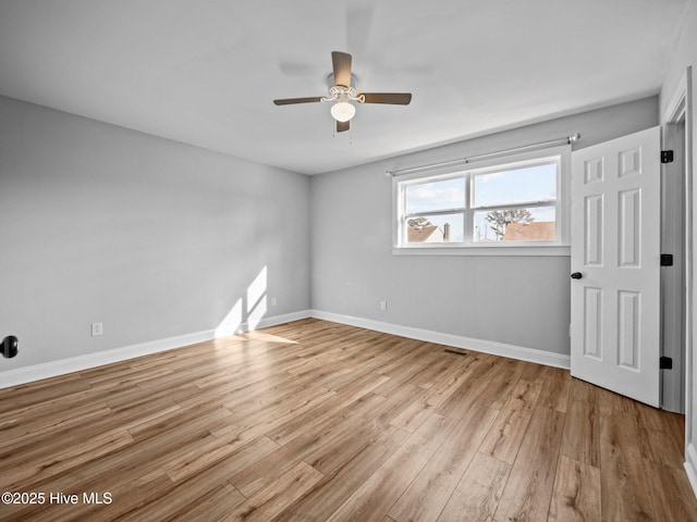 empty room with ceiling fan and light wood-type flooring