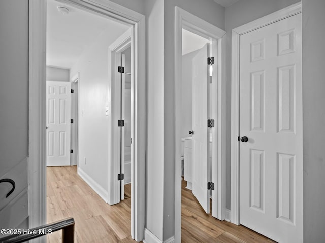 corridor with light hardwood / wood-style floors