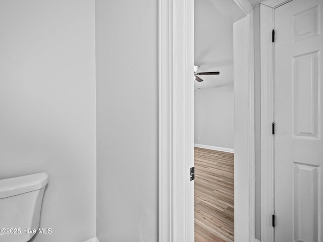 bathroom featuring hardwood / wood-style floors, ceiling fan, and toilet