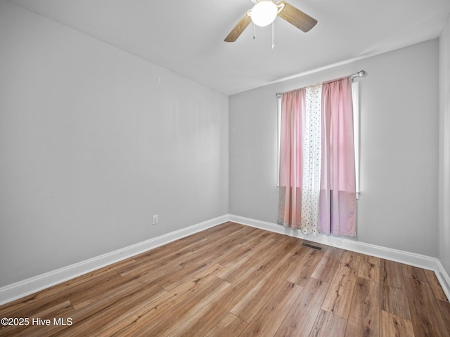 spare room with light hardwood / wood-style flooring and ceiling fan