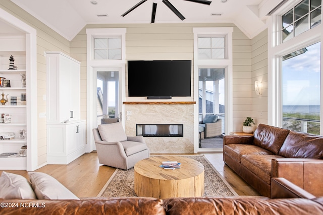 living room featuring a wealth of natural light, built in features, and hardwood / wood-style floors