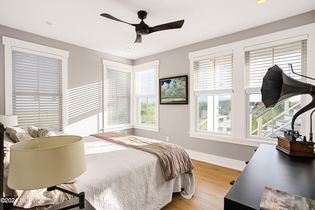 bedroom with ceiling fan and hardwood / wood-style floors