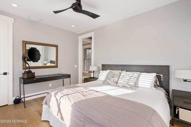 bedroom with ceiling fan and light hardwood / wood-style flooring