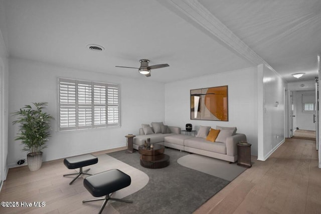 living room with ceiling fan and light wood-type flooring