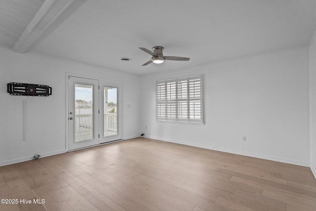 spare room with beamed ceiling, ceiling fan, and light wood-type flooring