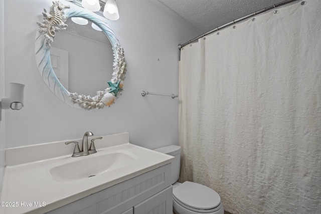 bathroom with vanity, a textured ceiling, and toilet