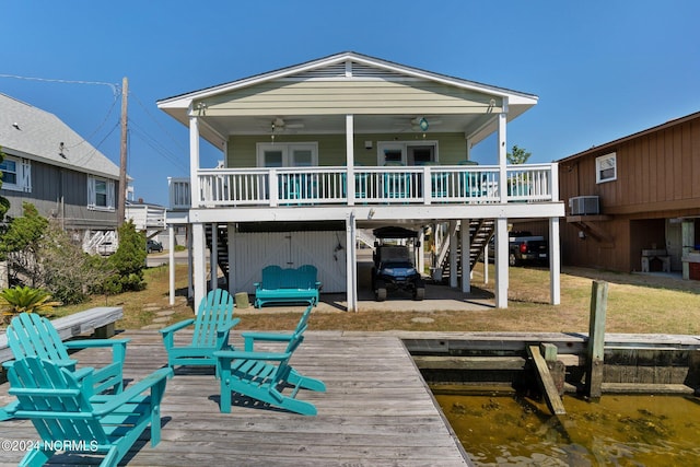 rear view of house with ceiling fan, a deck with water view, and central AC unit