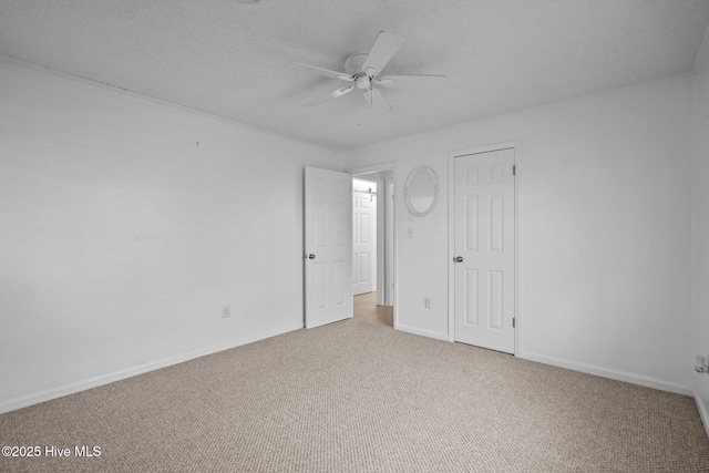 unfurnished bedroom featuring ceiling fan, light carpet, and a textured ceiling