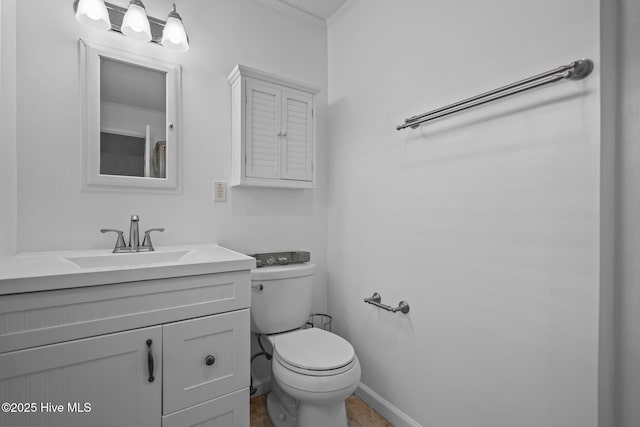 bathroom featuring crown molding, vanity, and toilet