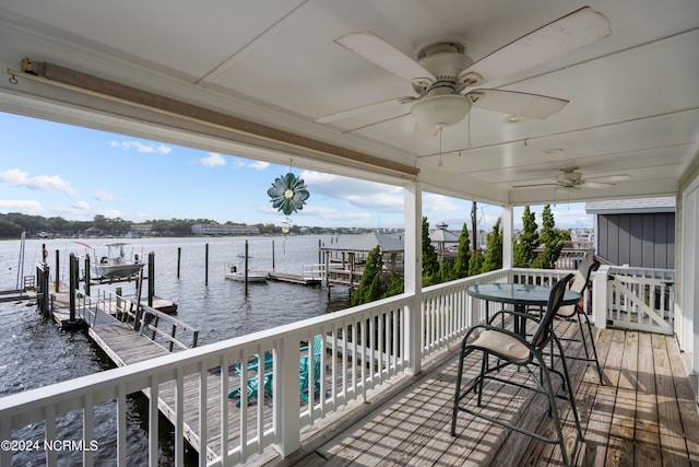 view of dock with a water view and ceiling fan