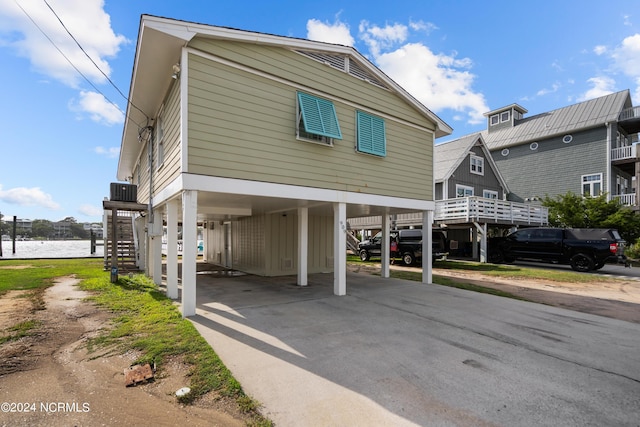 view of front of house featuring cooling unit and a carport