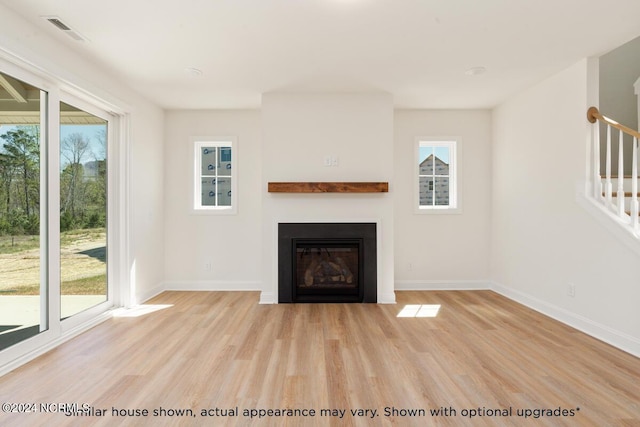 unfurnished living room with light wood-type flooring