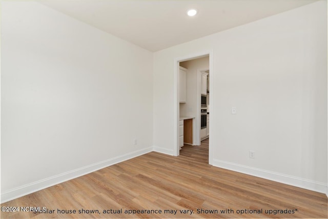 spare room featuring light hardwood / wood-style flooring