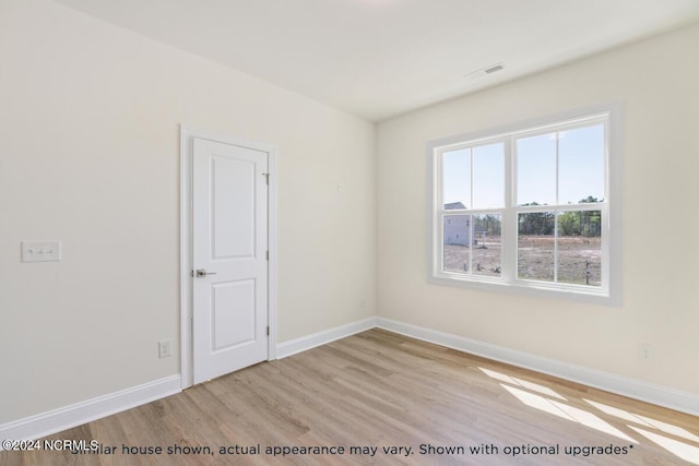 spare room featuring light hardwood / wood-style flooring