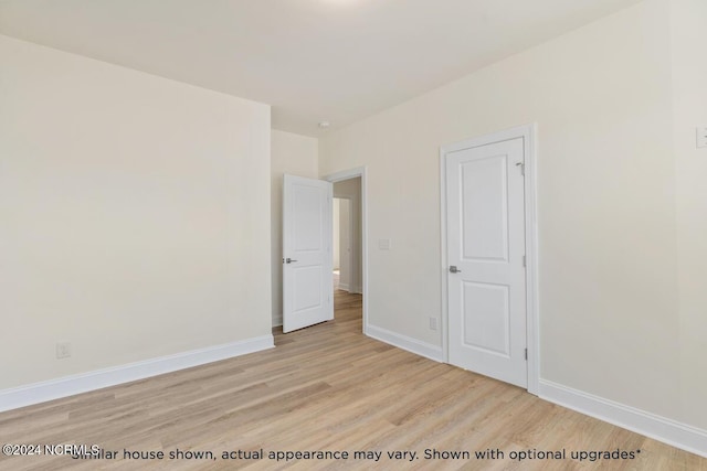 unfurnished bedroom featuring light wood-type flooring