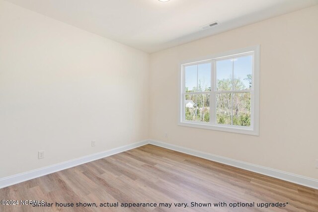 unfurnished room with light hardwood / wood-style flooring