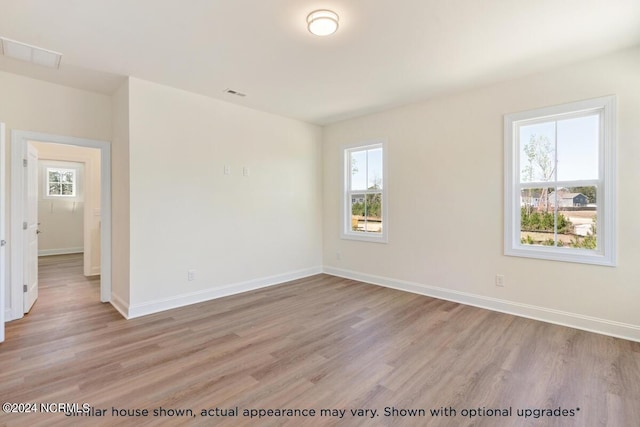 empty room featuring plenty of natural light and light wood-type flooring