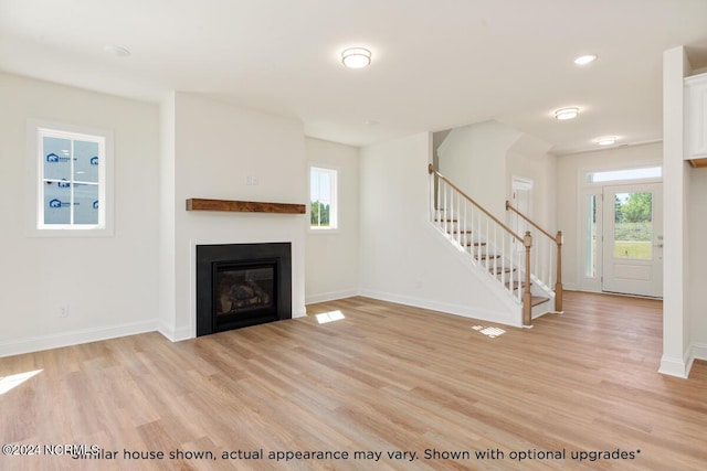 unfurnished living room featuring light wood-type flooring