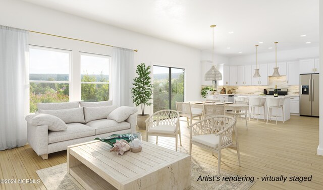 living area with light wood-type flooring and recessed lighting