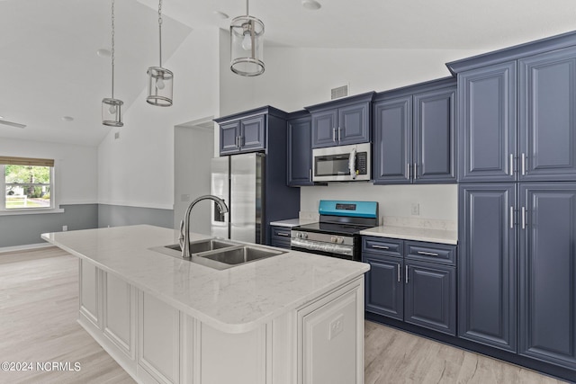 kitchen with sink, stainless steel appliances, light stone countertops, an island with sink, and vaulted ceiling