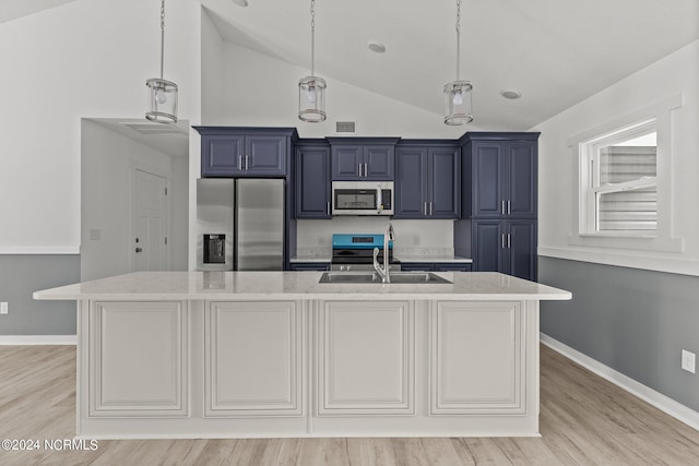 kitchen featuring light stone counters, sink, stainless steel appliances, and blue cabinets