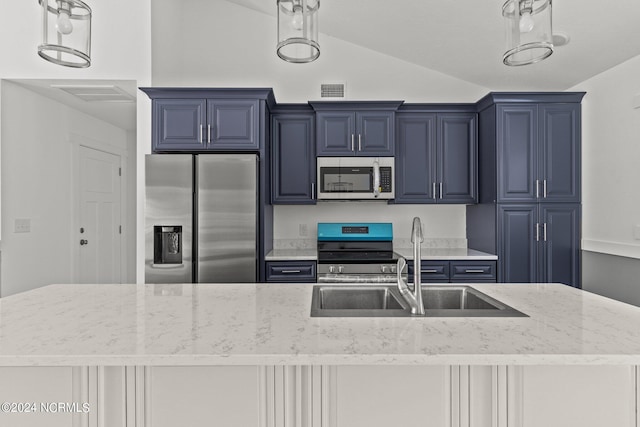 kitchen with blue cabinets, vaulted ceiling, light stone countertops, and appliances with stainless steel finishes