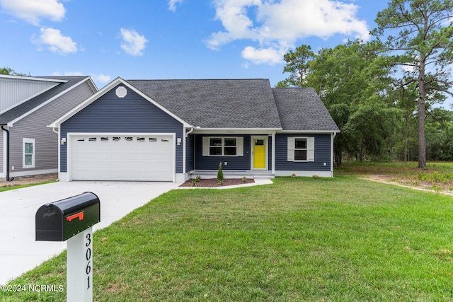 view of front of home with a garage, a front yard, driveway, and a shingled roof