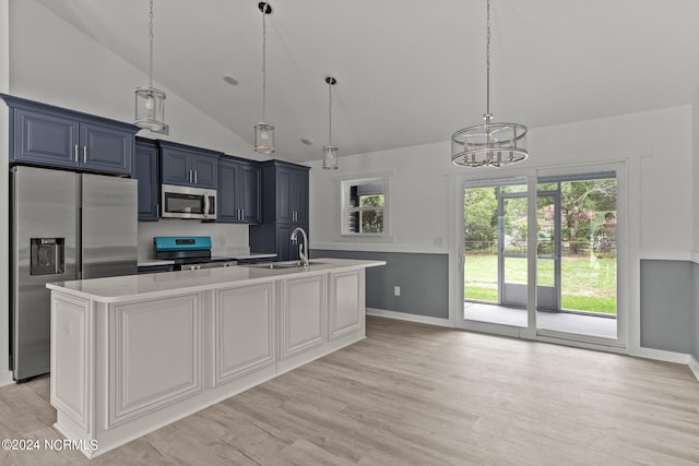 kitchen with a kitchen island with sink, sink, light hardwood / wood-style flooring, and stainless steel appliances