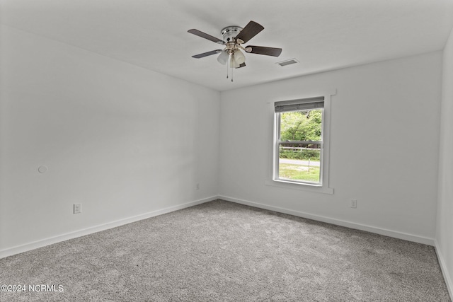 carpeted spare room with ceiling fan