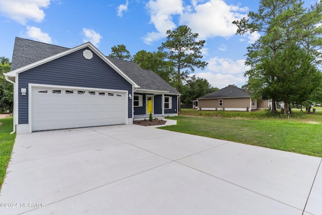 view of front of house with a garage and a front lawn