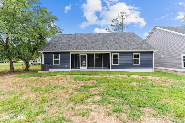 rear view of house with cooling unit, a yard, a patio, and a sunroom