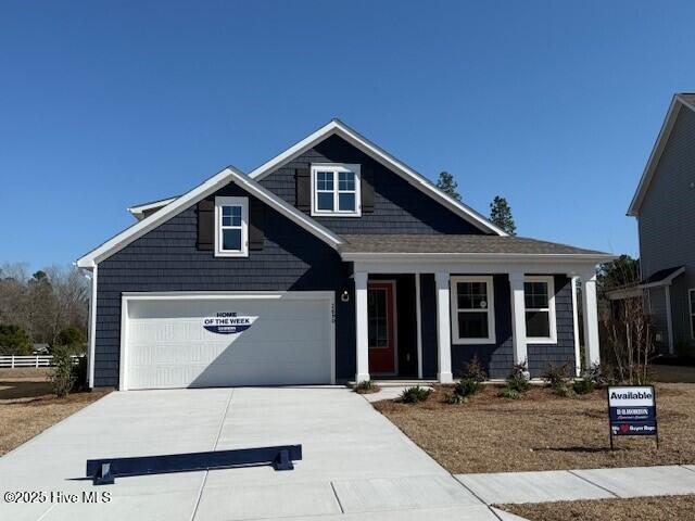 craftsman-style home featuring a garage and driveway