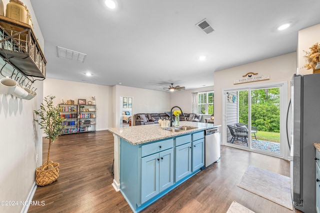 kitchen featuring visible vents, blue cabinetry, stainless steel appliances, a sink, and open floor plan