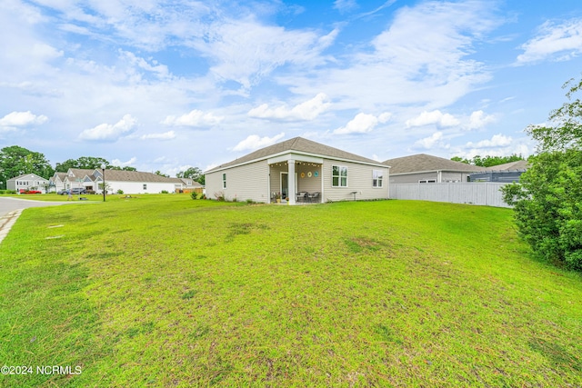 exterior space featuring a front yard and fence